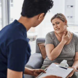 Chiropractor discussing treatment options with patient experiencing nerve pain.