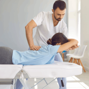 Chiropractor performing spinal adjustment for pinched nerve relief.